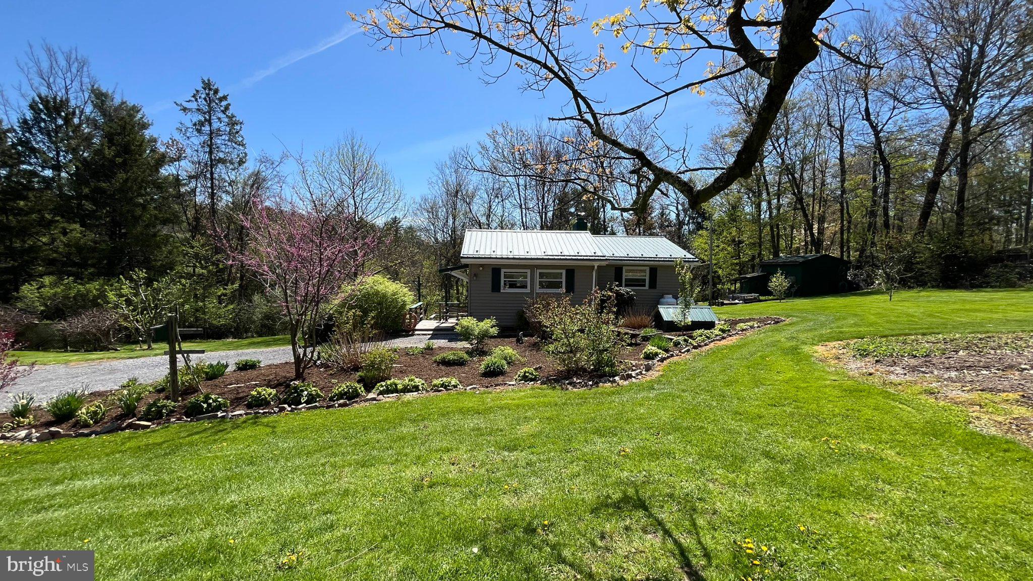 2290 Purdue Mountain Road Bellefonte, PA 16823 - Photo 36 of 48 Charming cottage amidst lush greenery.
