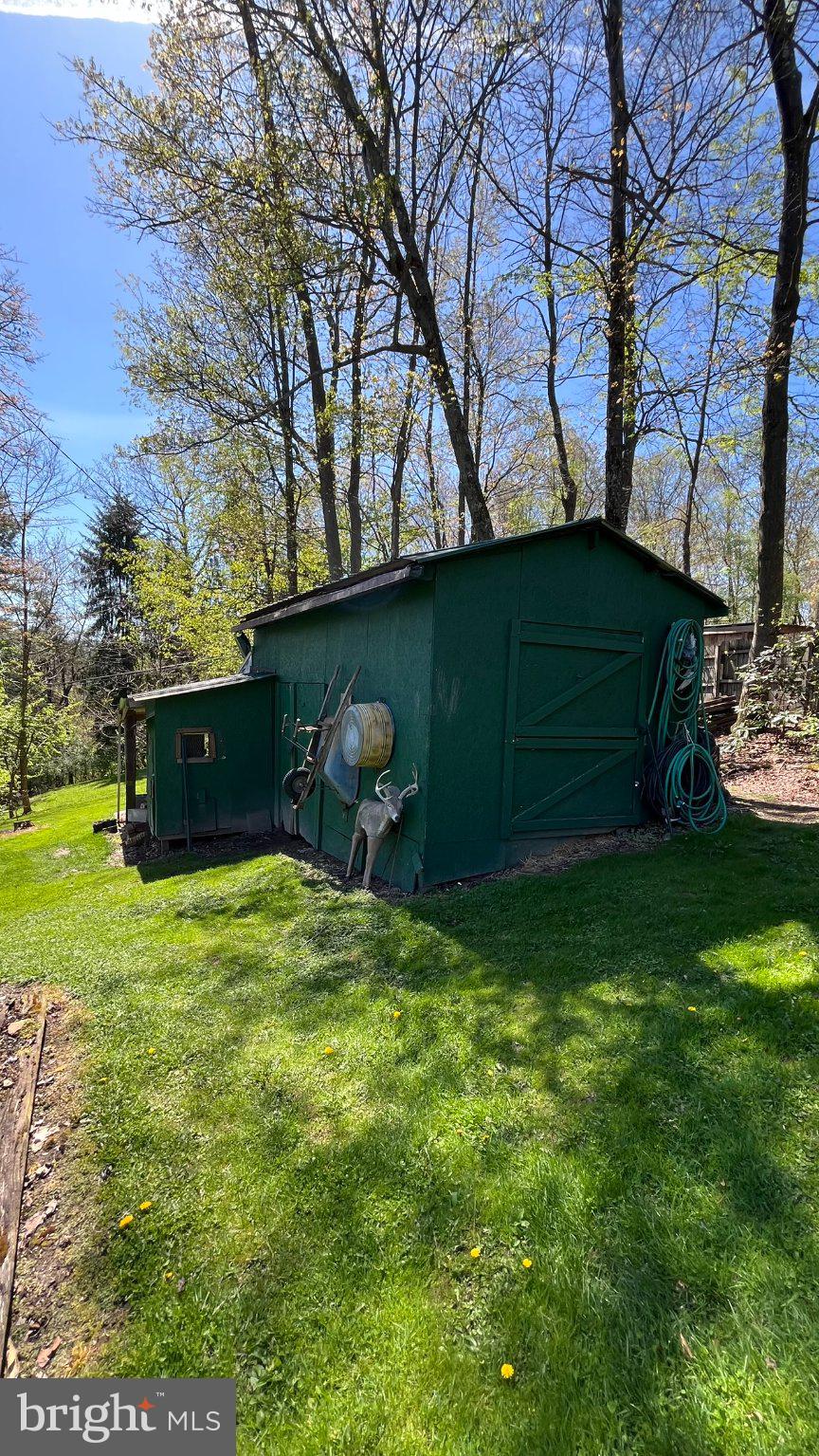 2290 Purdue Mountain Road Bellefonte, PA 16823 - Photo 48 of 48 Charming garden shed in lush greenery.