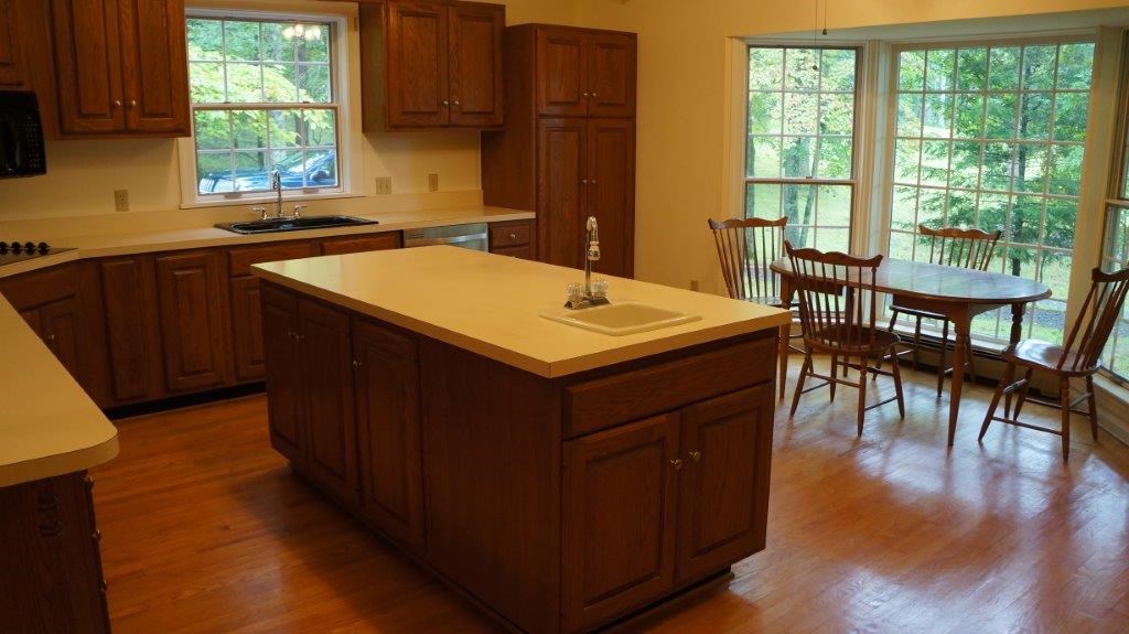 286 Beazley Road Ruckersville, VA 22968 - Photo 26 of 50 a kitchen with a wooden table and chairs