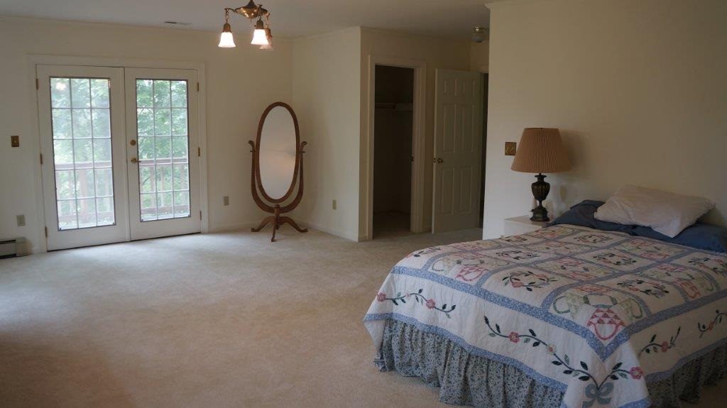286 Beazley Road Ruckersville, VA 22968 - Photo 40 of 50 a bedroom with a bed a mirror and a window