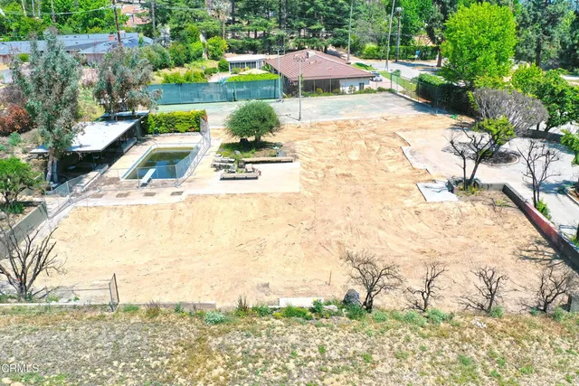 a view of a swimming pool with an outdoor seating and a yard
