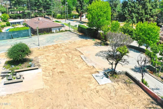 a backyard of a house with yard and outdoor seating