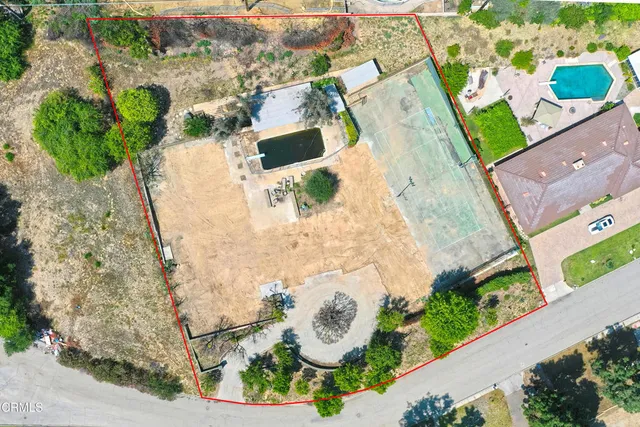 an aerial view of a house with a yard and lake view