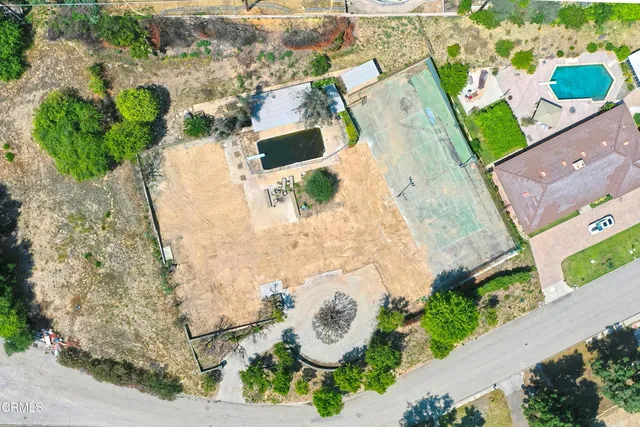 an aerial view of a house with a yard and lake view