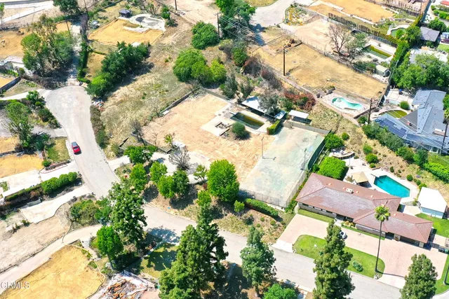 an aerial view of a house with a yard and garden