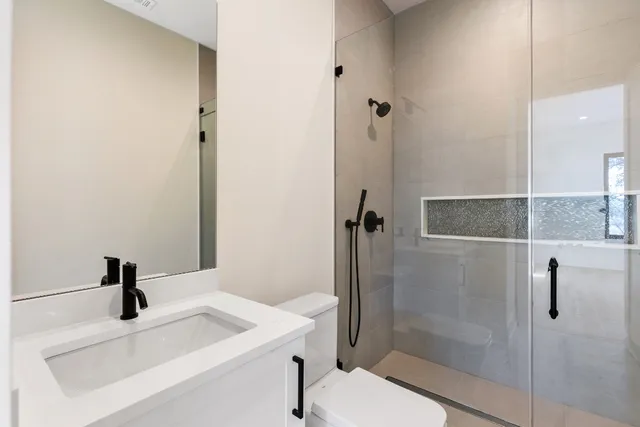 a bathroom with a tub sink and mirror