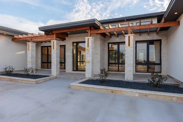 a view of a house with porch and furniture