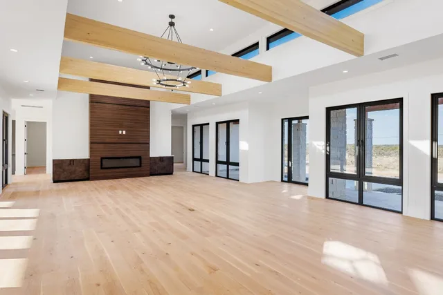 a view of an empty room with a kitchen