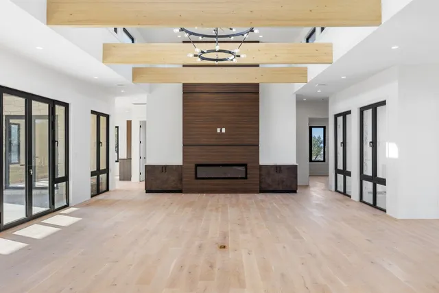 a large kitchen with cabinets a sink a window and stainless steel appliances