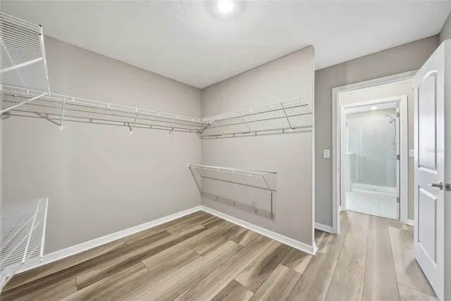 a view of a room with wooden floor