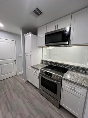 a kitchen with a stove and a microwave