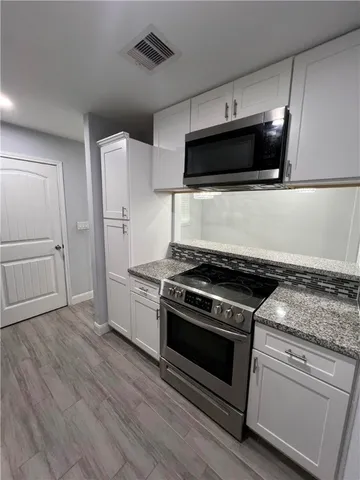 a kitchen with a stove and a microwave