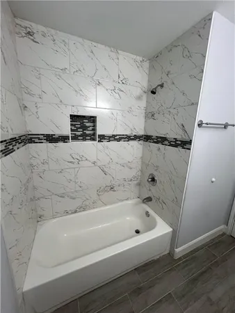 a bathroom with a bathtub and a shower