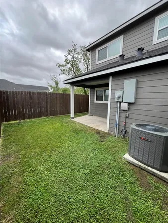 a view of a house with a backyard