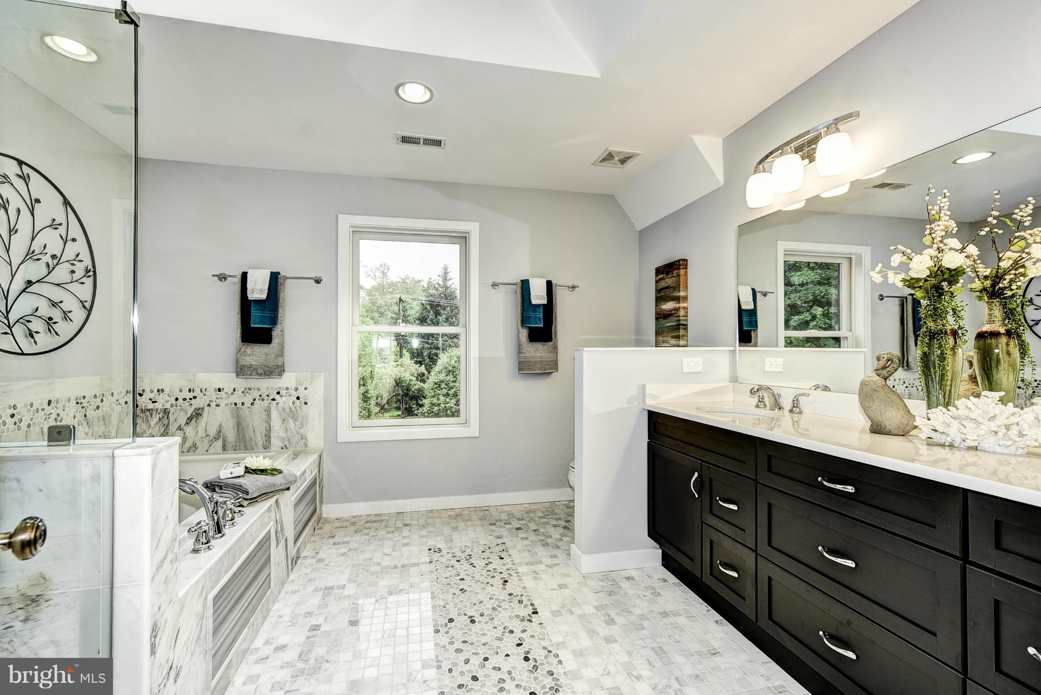 506 Midland Road Silver Spring, MD 20904 - Photo 11 of 28 a spacious bathroom with a double vanity sink toilet mirror and bathtub
