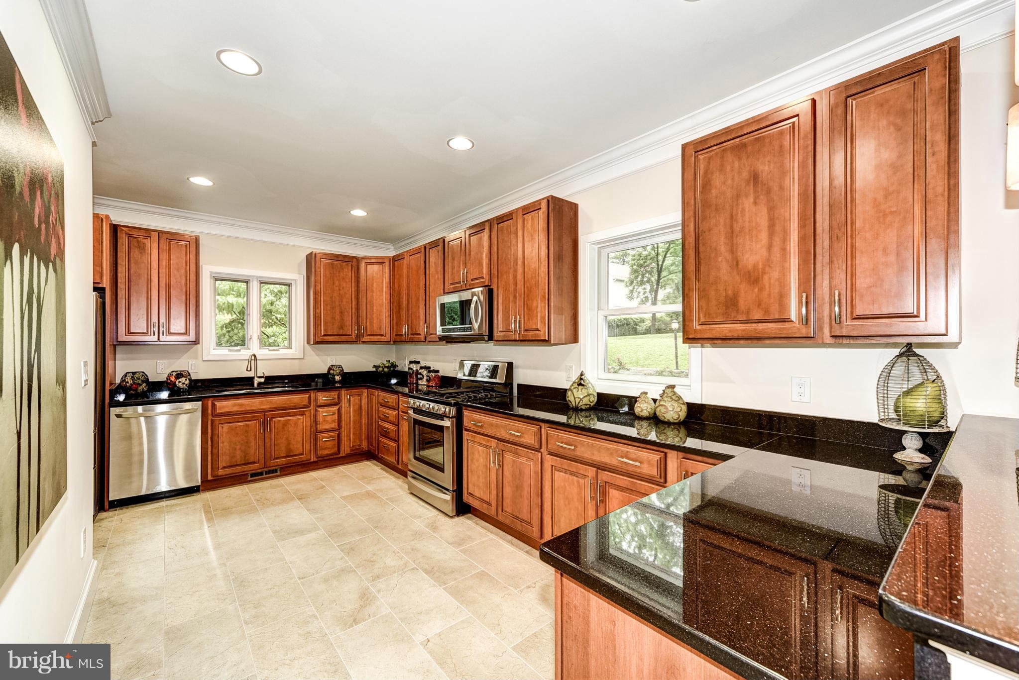 506 Midland Road Silver Spring, MD 20904 - Photo 22 of 28 a kitchen with stainless steel appliances granite countertop a sink and cabinets