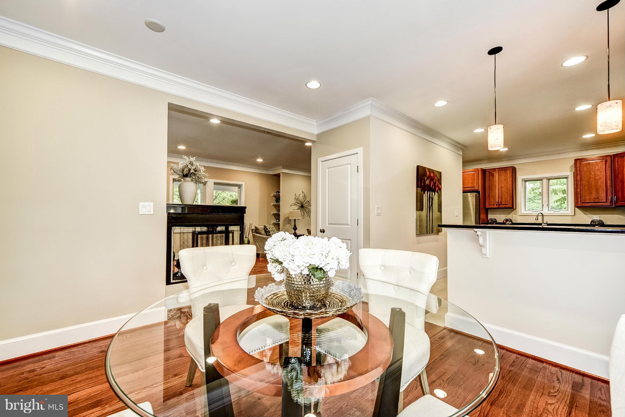 506 Midland Road Silver Spring, MD 20904 - Photo 7 of 28 a dining room with furniture a chandelier and kitchen view
