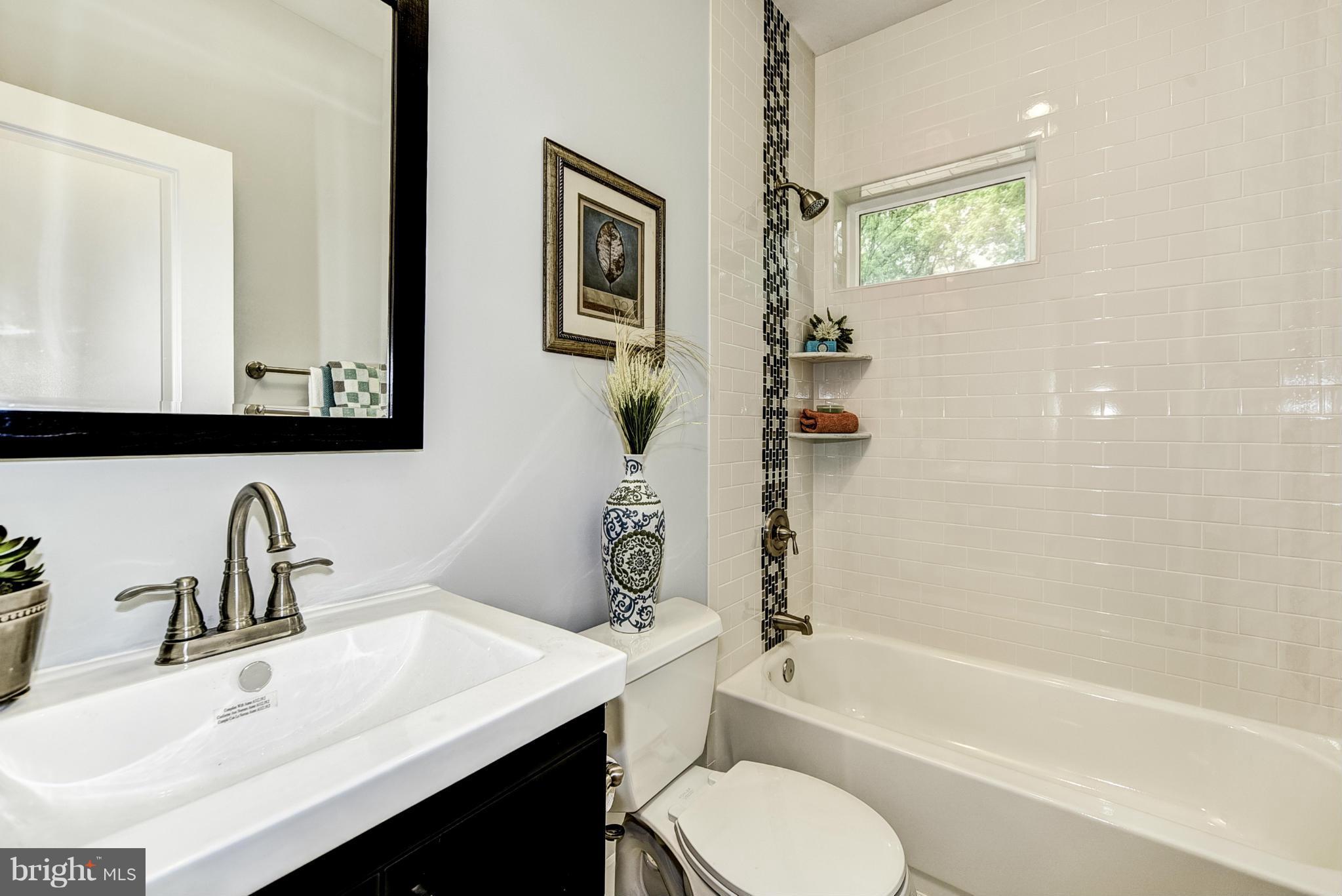 506 Midland Road Silver Spring, MD 20904 - Photo 8 of 28 a bathroom with a granite countertop sink toilet and shower