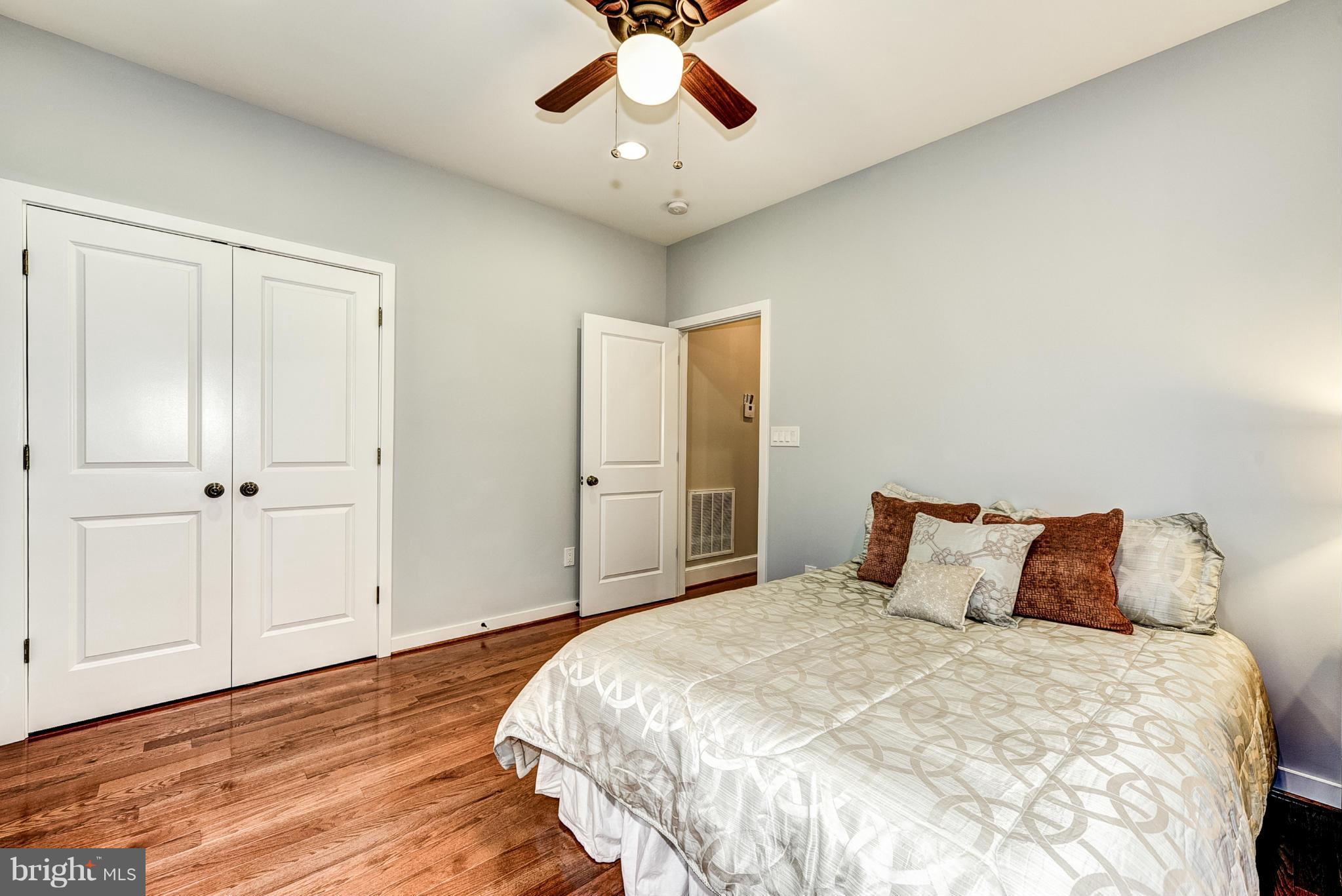 506 Midland Road Silver Spring, MD 20904 - Photo 10 of 28 a bedroom with a large bed and a chandelier