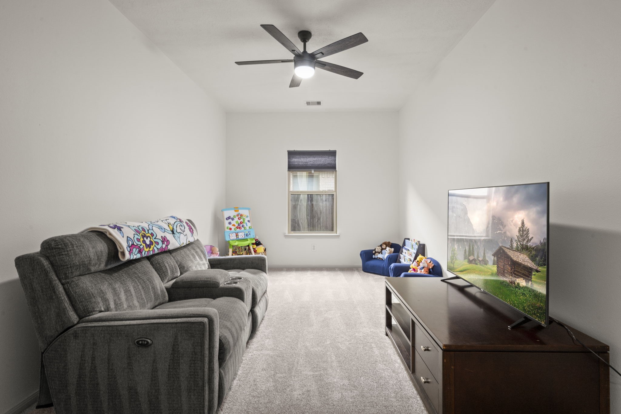 27526 Gatlin Lane Spring, TX 77386 - Photo 12 of 31 This inviting room is perfect for cozy movie nights, quality family time, and unwinding after a long day.