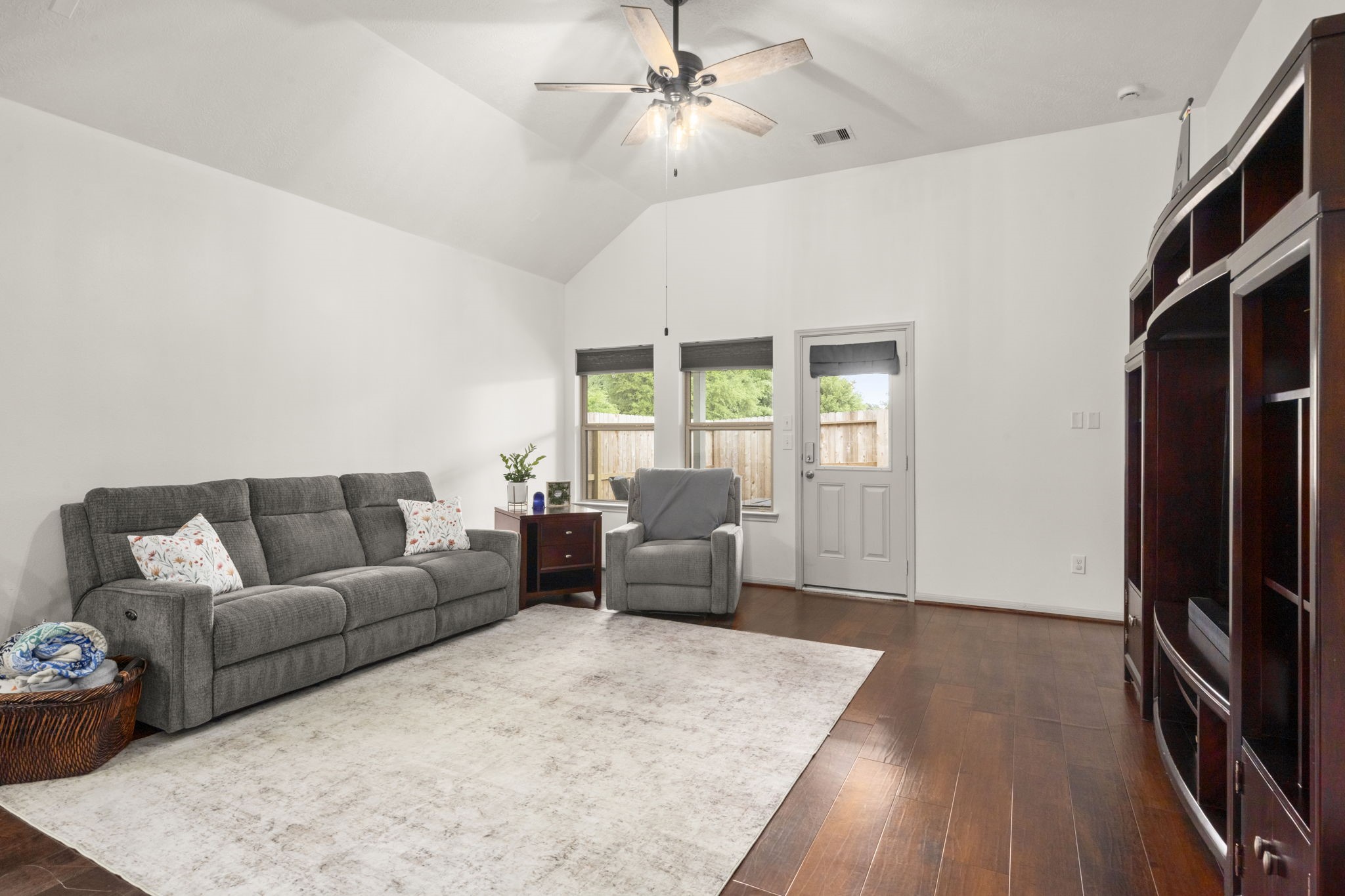 27526 Gatlin Lane Spring, TX 77386 - Photo 19 of 31 This living room showcases high ceilings, natural light, and warm wood flooring—creating a welcoming entertainment space.