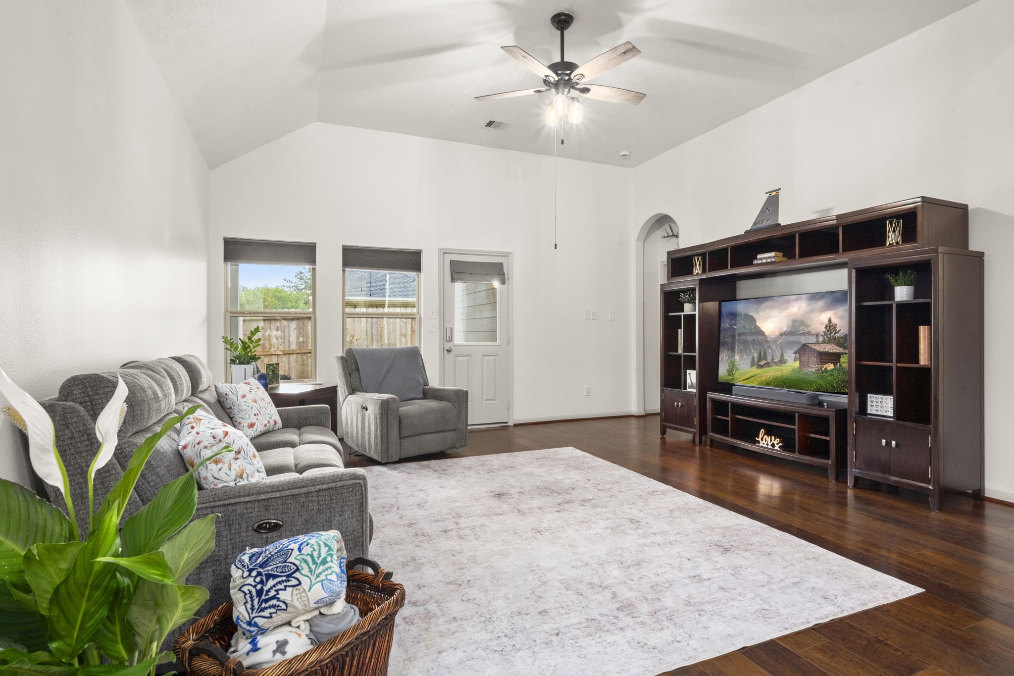 27526 Gatlin Lane Spring, TX 77386 - Photo 20 of 31 Living room with gleaming hardwood floors and natural light throughout, creating a bright, open feel with direct backyard connection.