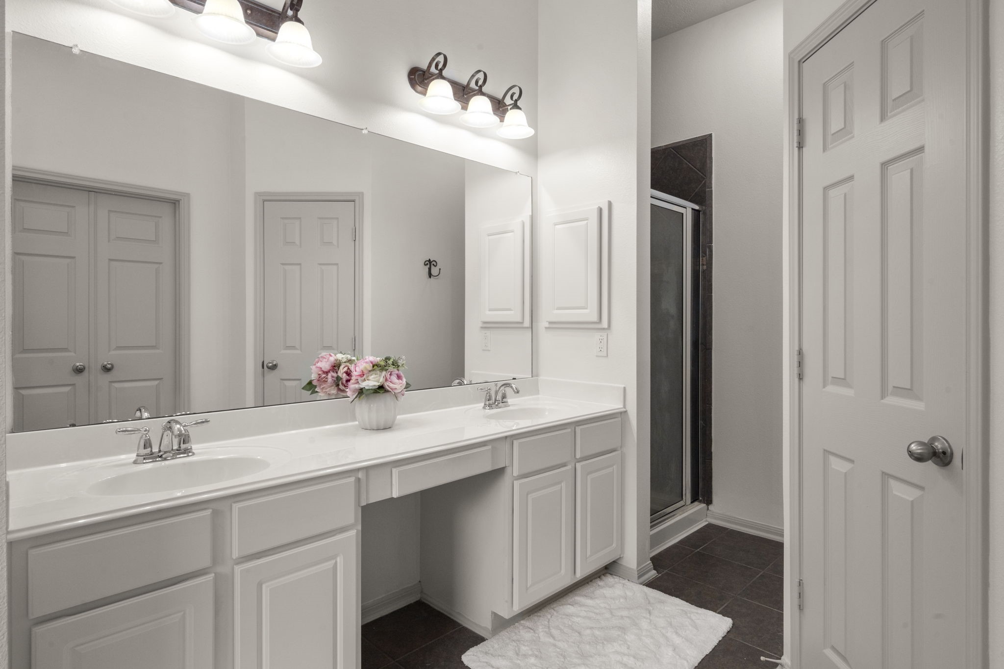 27526 Gatlin Lane Spring, TX 77386 - Photo 24 of 31 Spacious His and Hers bathroom with dual sinks, a large mirror, elegant lighting, and a sleek shower area.