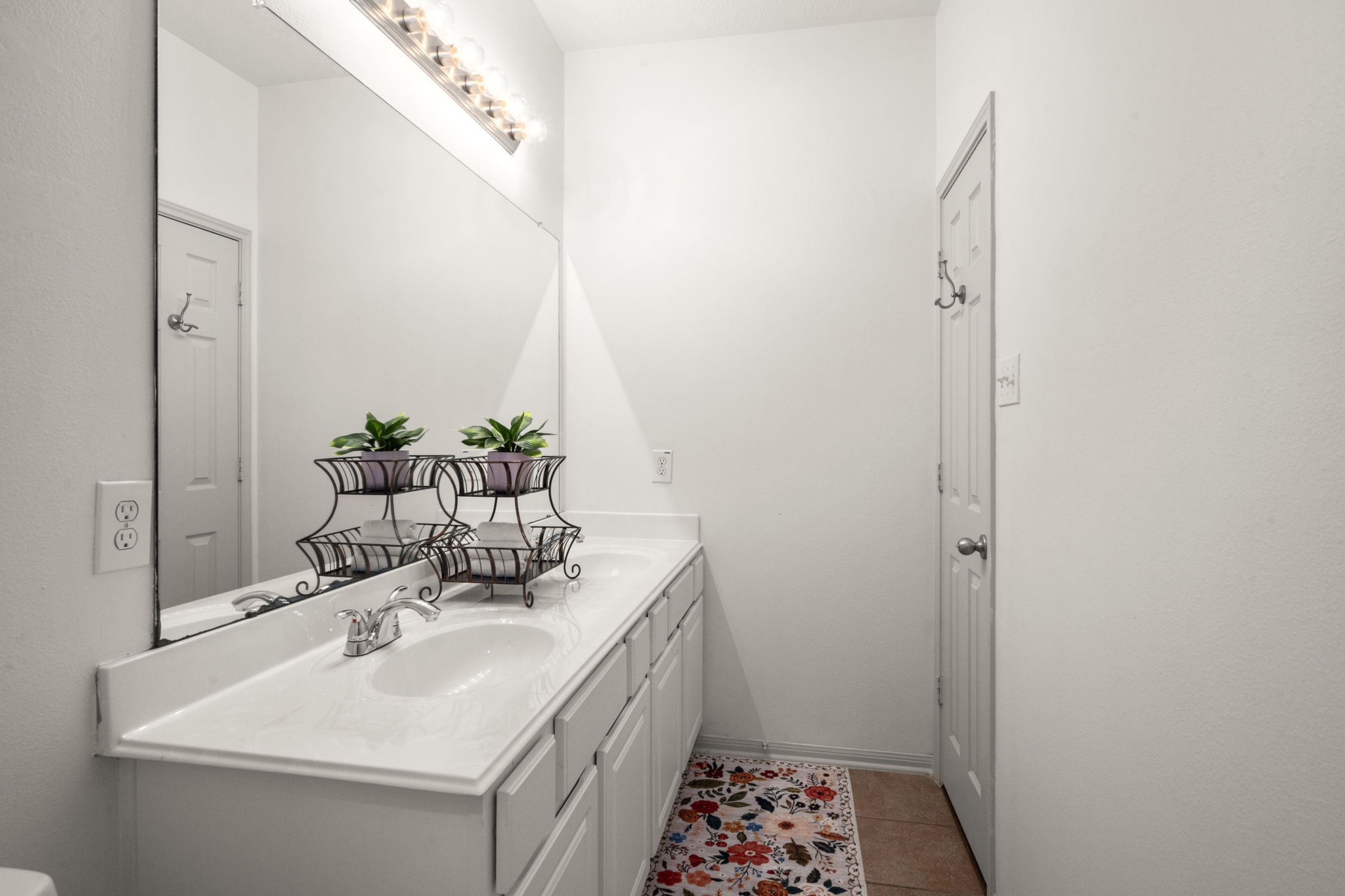 27526 Gatlin Lane Spring, TX 77386 - Photo 28 of 31 This guest bathroom offers a double-sink white vanity, large mirror, and modern lights.
