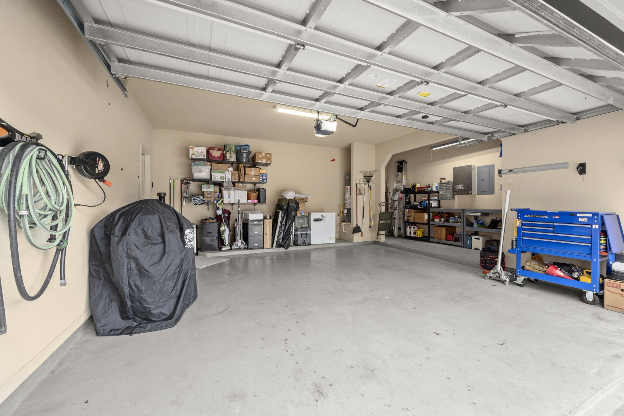27526 Gatlin Lane Spring, TX 77386 - Photo 30 of 31 Extended garage with ample tool storage and built-in shelves. Features a ground-level water heater—no more climbing into the attic for maintenance.