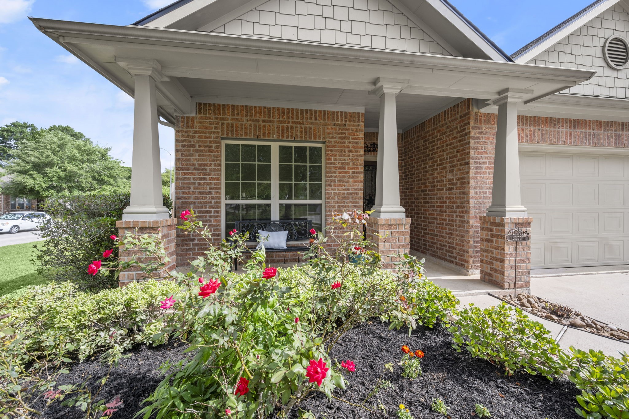 27526 Gatlin Lane Spring, TX 77386 - Photo 7 of 31 Thoughtfully maintained landscaping create a peaceful setting, while the generous front porch invites you to unwind.