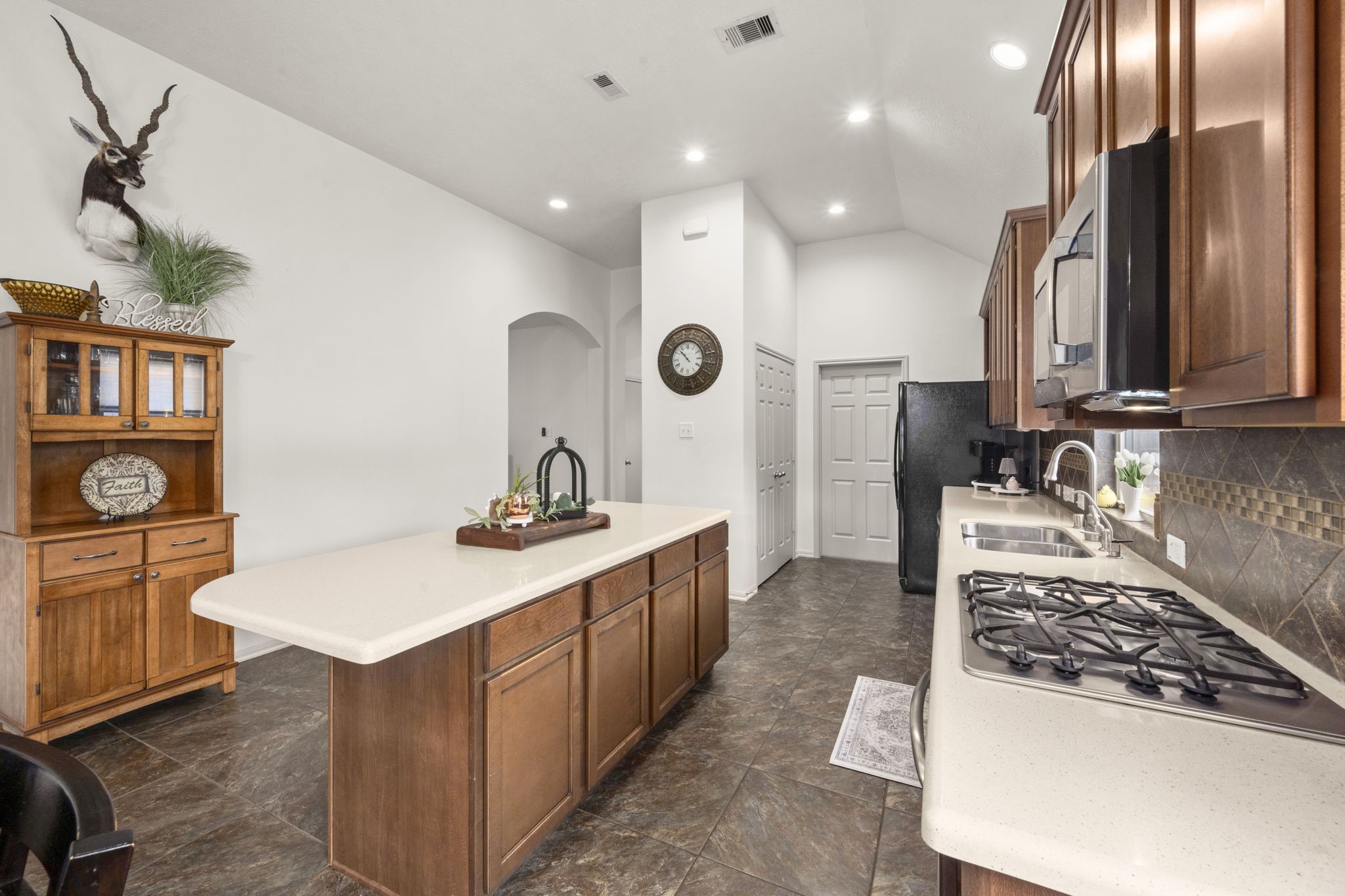 27526 Gatlin Lane Spring, TX 77386 - Photo 9 of 31 This charming kitchen combines classic wood cabinetry with a practical island