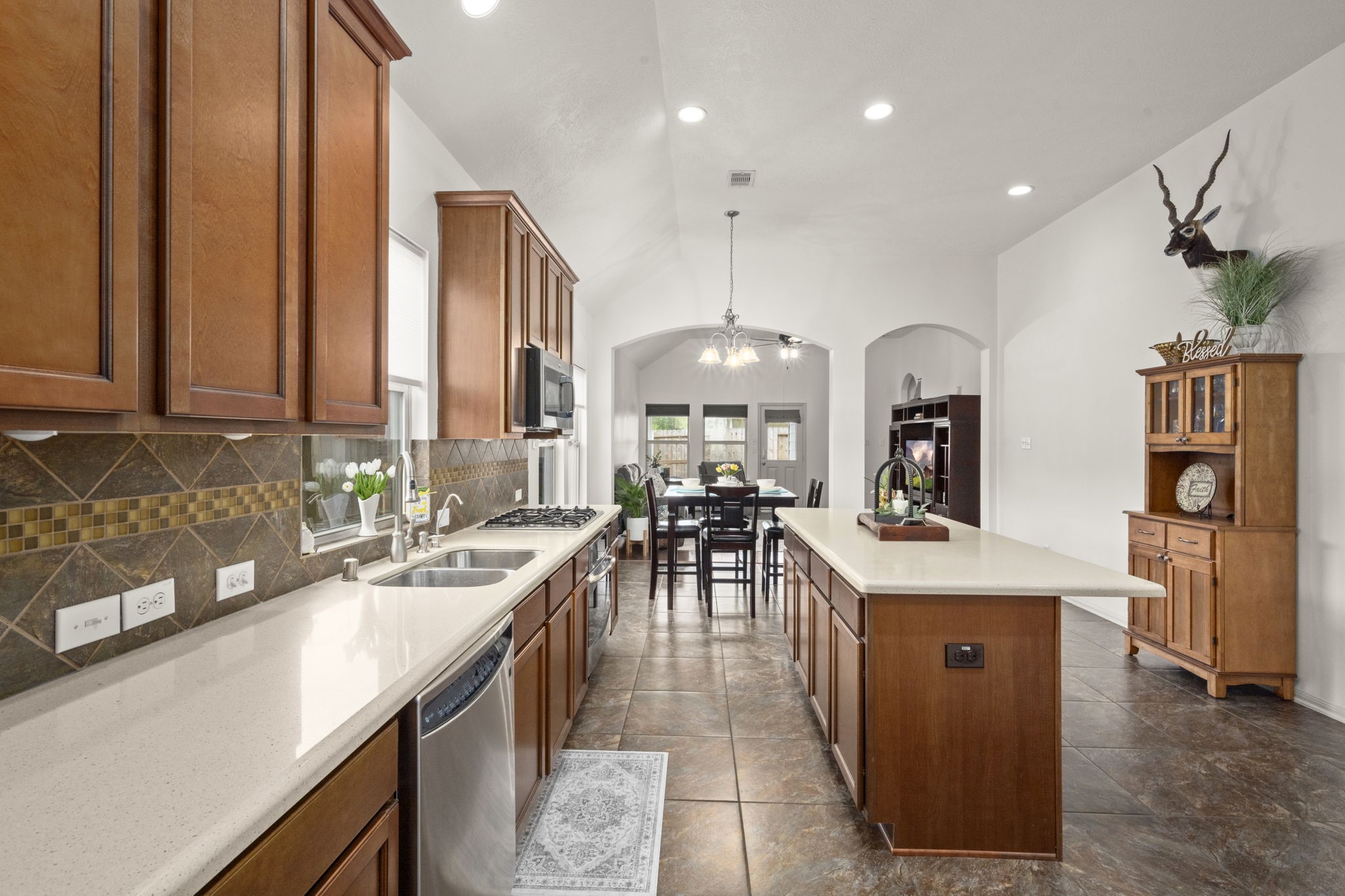27526 Gatlin Lane Spring, TX 77386 - Photo 10 of 31 The open design connects beautifully to a bright, airy hallway enhanced by graceful arches and stylish lighting, making it ideal for both everyday living and entertaining.