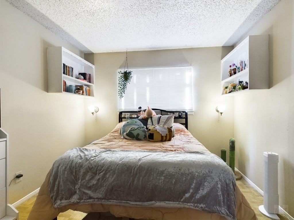 803 West 28th Street, Unit 105 Austin, TX 78705 - Photo 12 of 40 a bedroom with a bed and wall painting