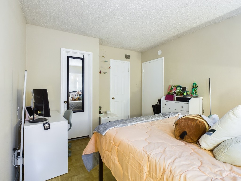 803 West 28th Street, Unit 105 Austin, TX 78705 - Photo 13 of 40 a bedroom with a bed and a flat screen tv