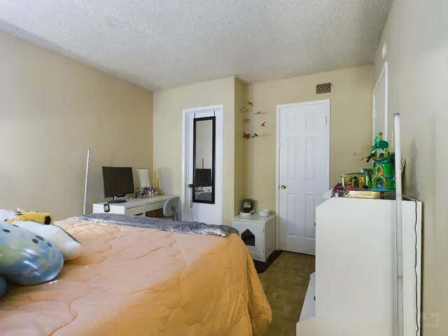 a bedroom with a bed and a flat screen tv