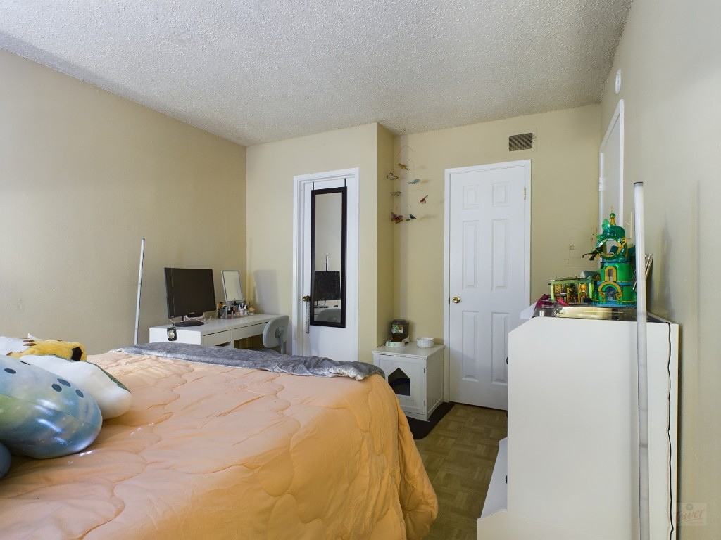 803 West 28th Street, Unit 105 Austin, TX 78705 - Photo 14 of 40 a bedroom with a bed and a flat screen tv