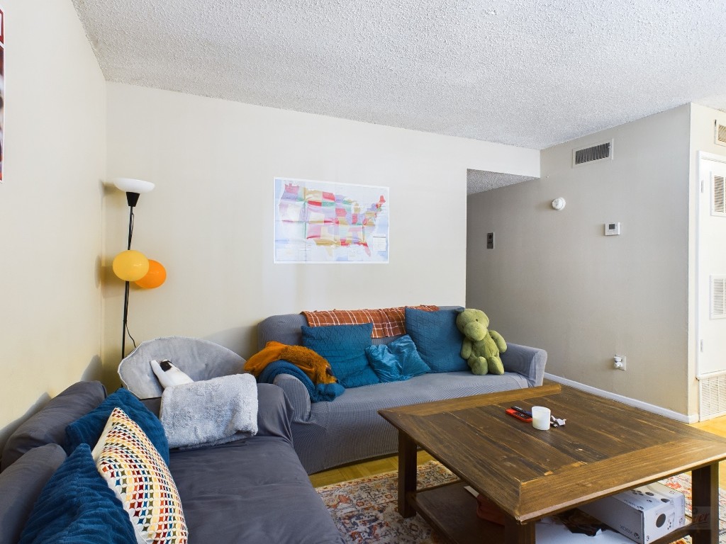 803 West 28th Street, Unit 105 Austin, TX 78705 - Photo 2 of 40 a living room with furniture and a table