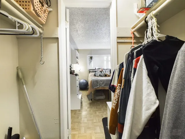 a bedroom with a bed and a desk