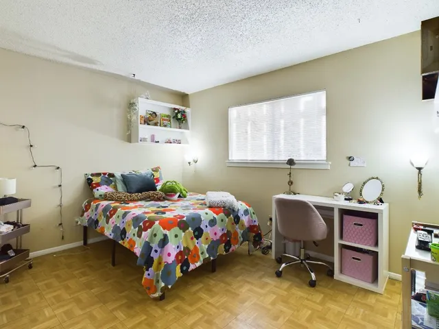 a bedroom with a bed and flat screen tv