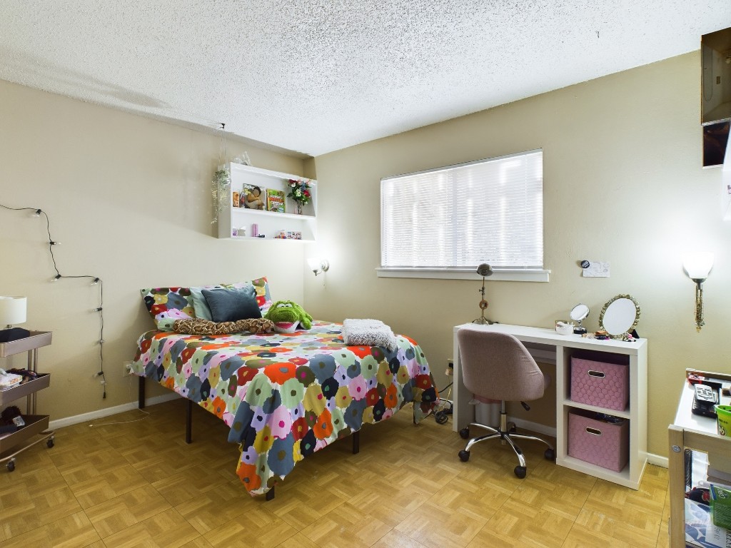 803 West 28th Street, Unit 105 Austin, TX 78705 - Photo 23 of 40 a bedroom with a bed and a desk