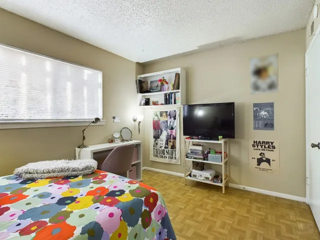 a bedroom with a bed and a flat screen tv