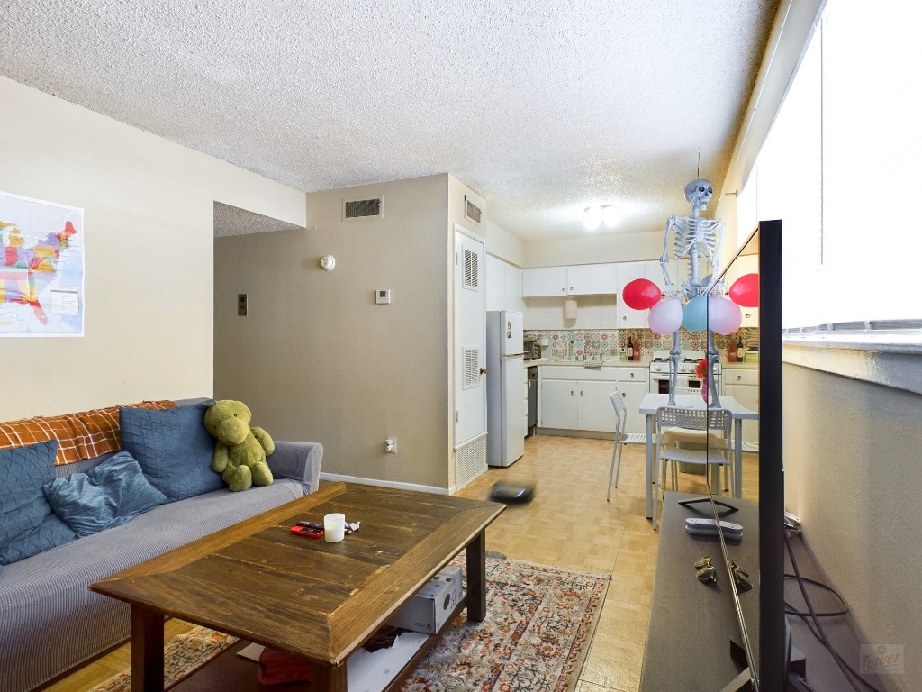 803 West 28th Street, Unit 105 Austin, TX 78705 - Photo 3 of 40 a living room with furniture and a table