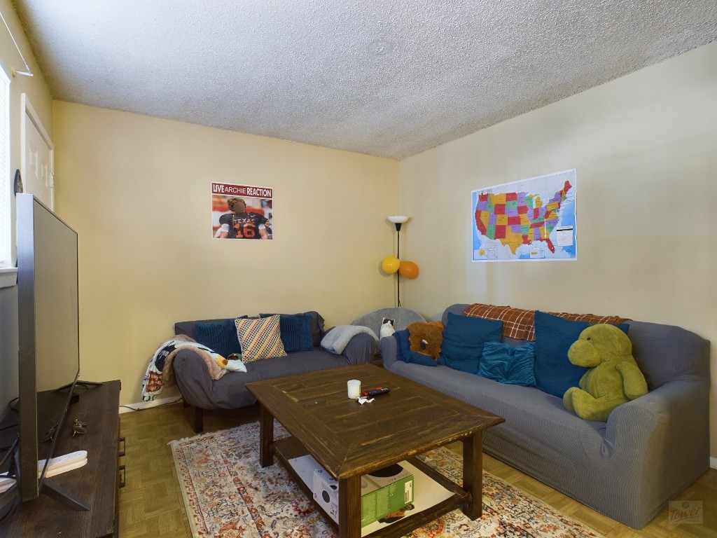 803 West 28th Street, Unit 105 Austin, TX 78705 - Photo 5 of 40 a living room with furniture and a couch