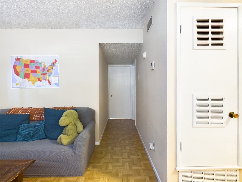 803 West 28th Street, Unit 105 Austin, TX 78705 - Photo 6 of 40 a living room with furniture and wooden floor