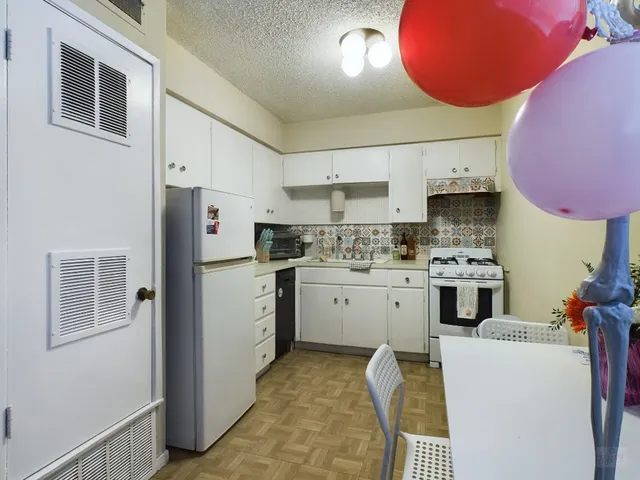 a kitchen with a sink cabinets and window