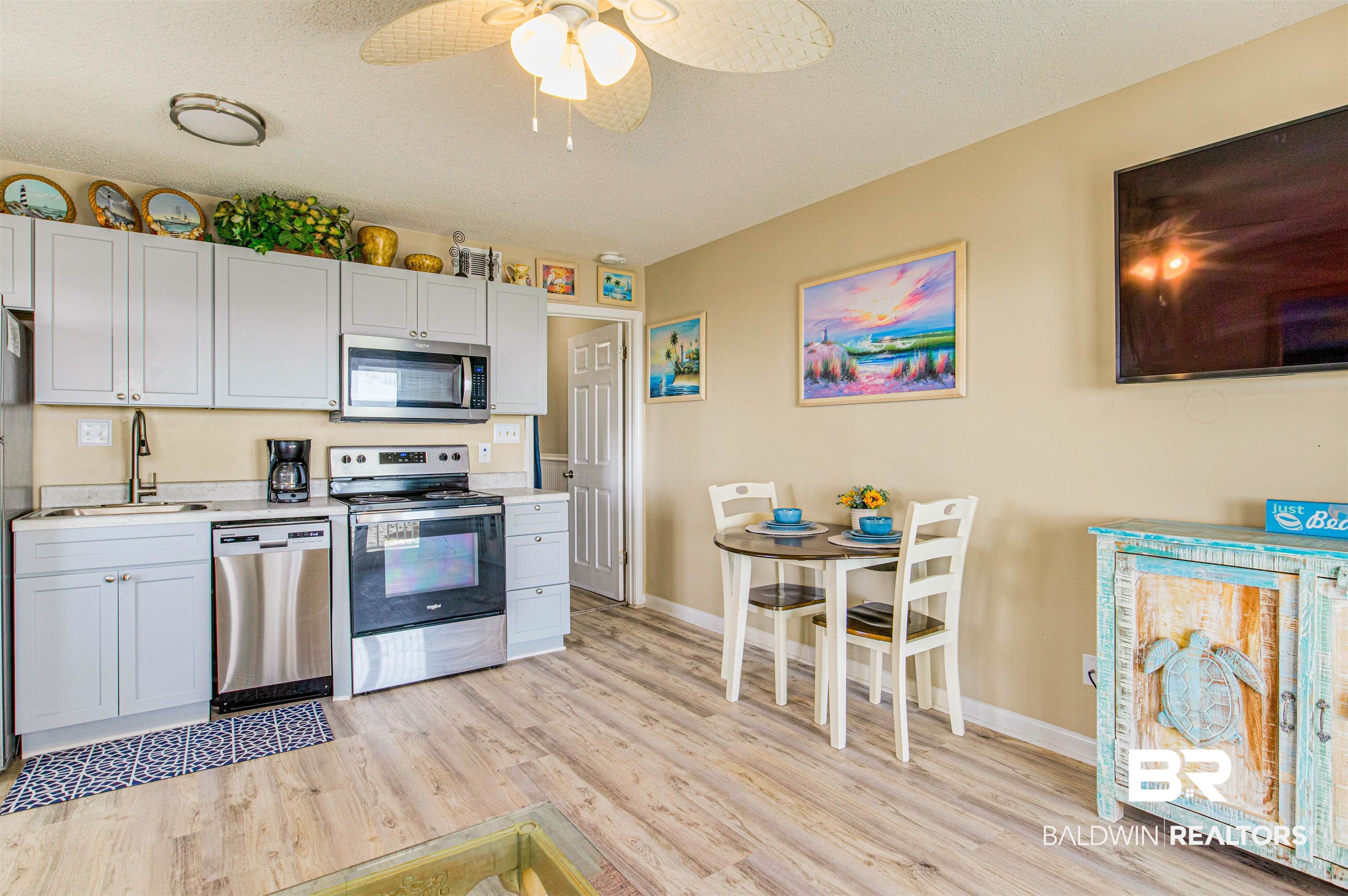 400 Plantation Road, Unit 1303 Gulf Shores, AL 36542 - Photo 6 of 24 Kitchen with stainless steel appliances open to living/dining areas