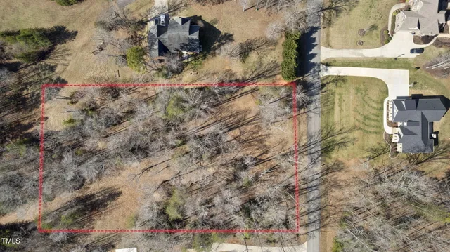 an aerial view of house with yard and mountain view in back