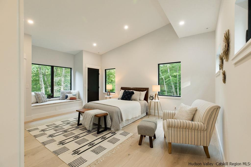 136 Bush Road Stone Ridge, NY 12484 - Photo 20 of 35 a spacious bedroom with a bed and a couch