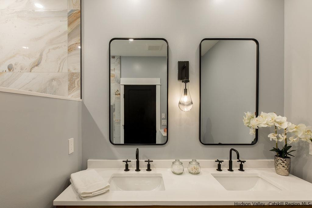 136 Bush Road Stone Ridge, NY 12484 - Photo 23 of 35 a bathroom with double vanity sinks and a mirror