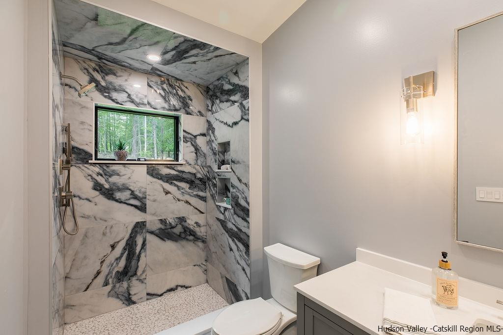 136 Bush Road Stone Ridge, NY 12484 - Photo 24 of 35 a bathroom with a sink toilet and window